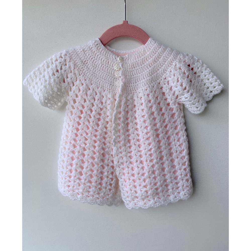 Cute little white hand knit baby sweater cardigan with pink lining